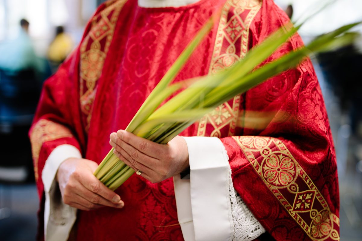 Priest holding palms